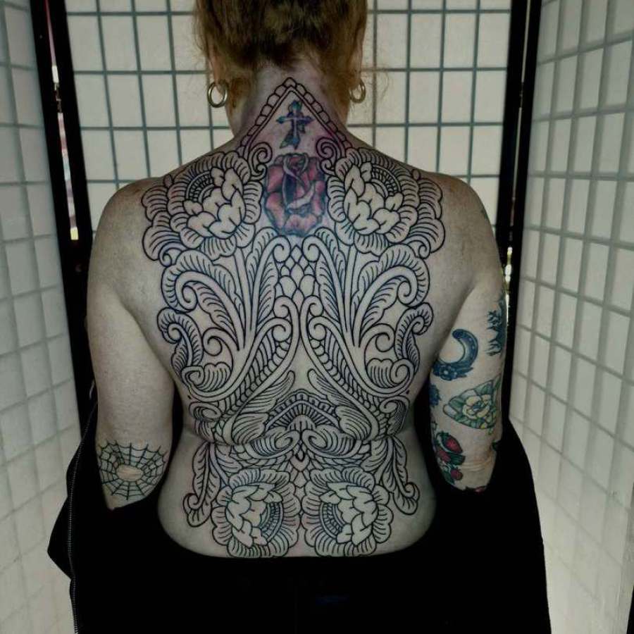 Ornamental floral back tattoo female done in Worthing uk